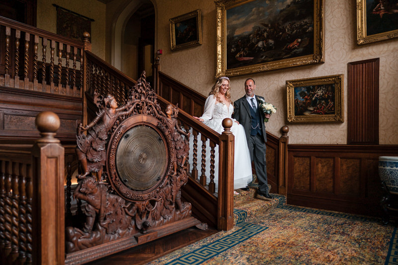 Bride on the staircase entrance at Armathwaite Hall