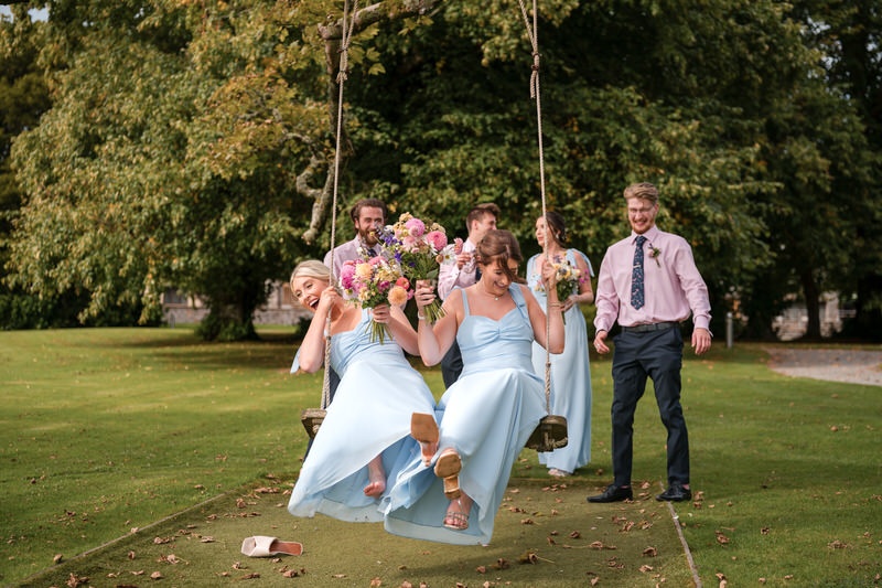 Bridesmaids having fun on a swing at Armathwaite Hall wedding