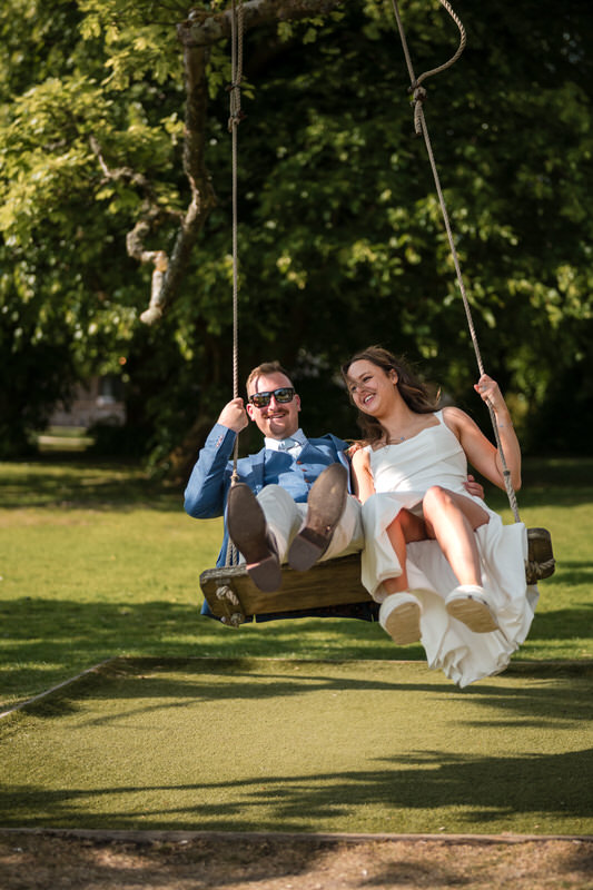 Wedding couple portrait on a garden swing at Armathwaite Hall