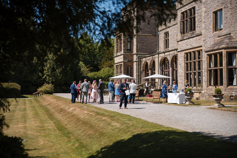 Wedding guests during drinks on the terrace at Armathwaite Hall