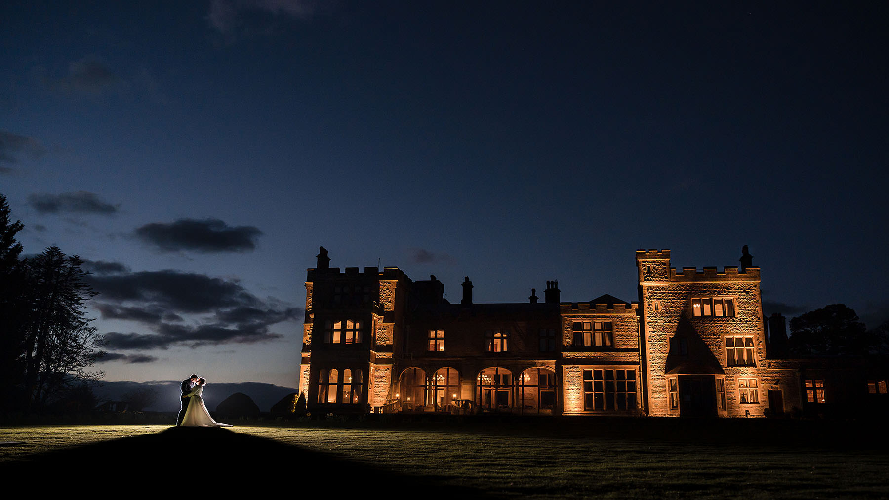 Wedding couple outside Armathwaite Hall at night in the Lake District