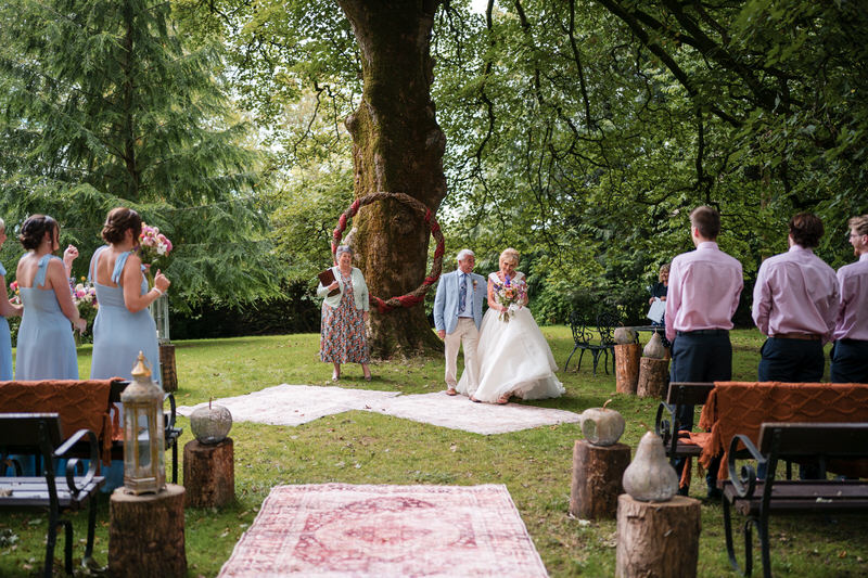 Aisle walk during an outdoor ceremony at Armathwaite Hall