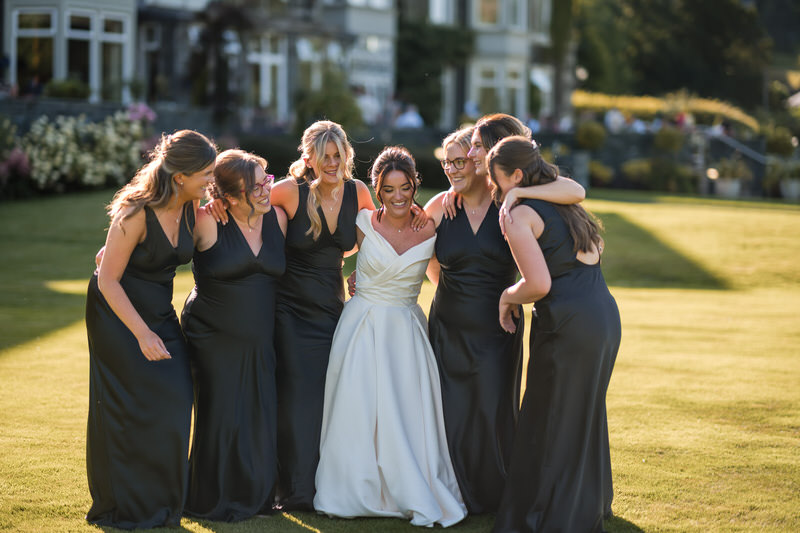 Bride and bridesmaids group portrait in the gardens at Inn on the Lake