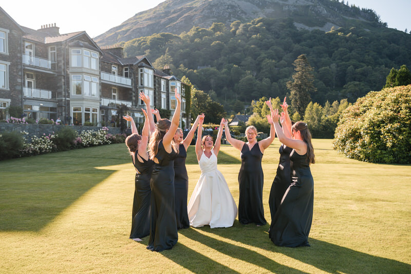 Bride and bridesmaids celebrating on the lawn at Inn on the Lake