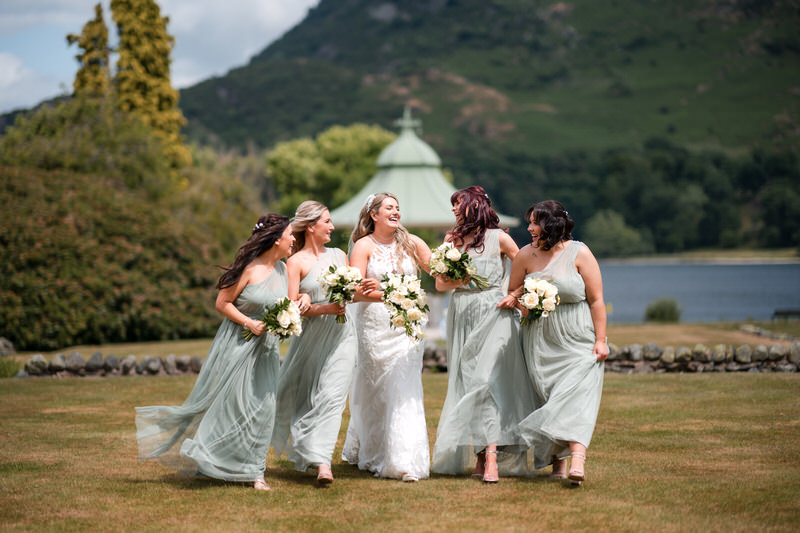 Bride and bridesmaids walking through the gazebo gardens at Inn on the Lake