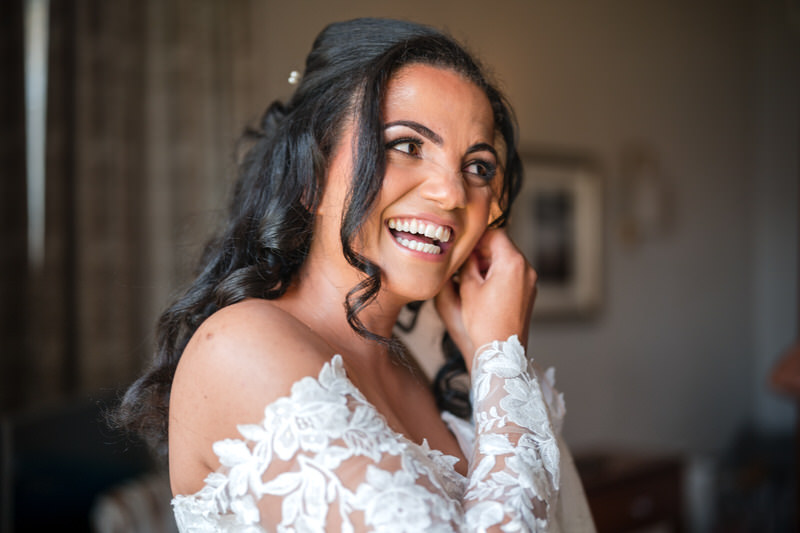 Bride smiling during preparations at Inn on the Lake wedding venue