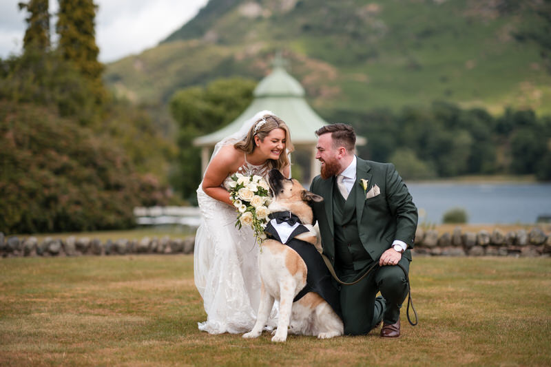 Wedding couple with dog portrait in the gazebo gardens at Inn on the Lake