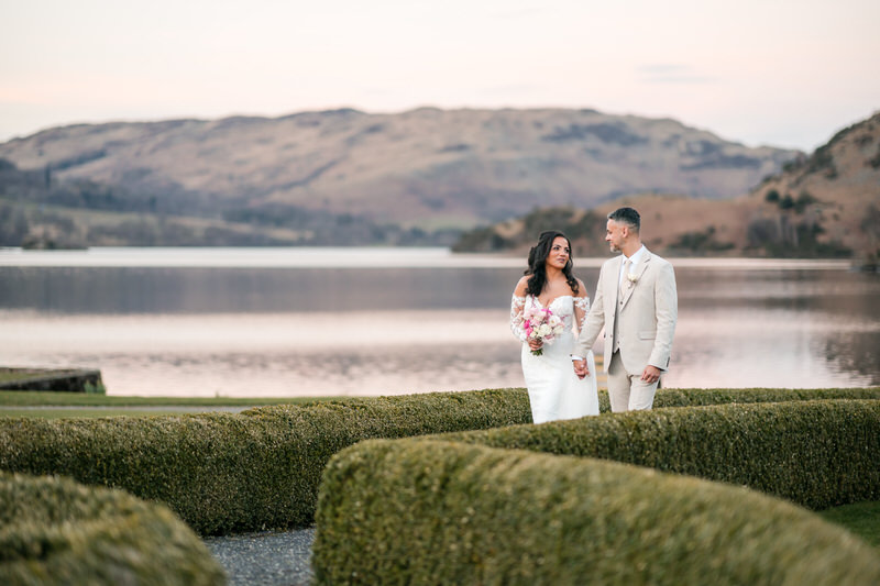 Wedding couple garden walk with lake view at Inn on the Lake on Ullswater