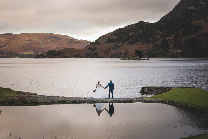 Wedding couple landscape portrait by the lakeshore at Inn on the Lake on Ullswater