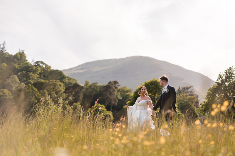 Wedding couple meadow portrait near Inn on the Lake in the Lake District