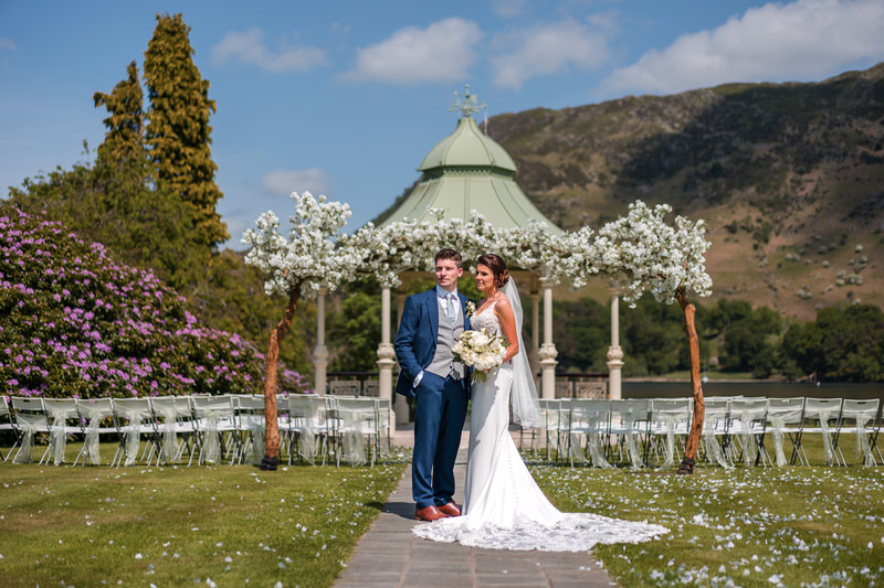 Wedding couple portrait by the gazebo ceremony arch at Inn on the Lake