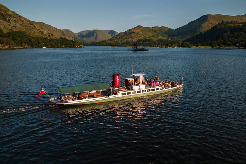 Aerial view of Ullswater steamer with wedding guests near Inn on the Lake