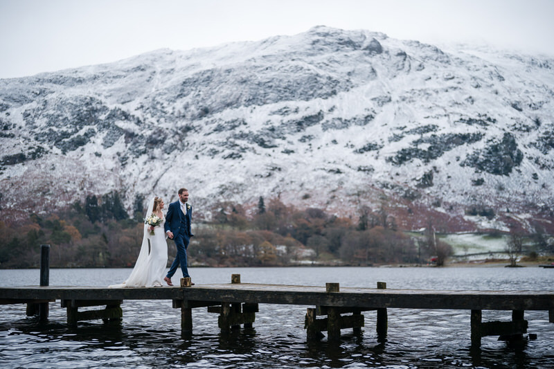 Winter jetty wedding couple portrait at Inn on the Lake on Ullswater