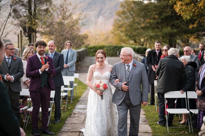 Bride and groom cheering on a boat near Lodore Falls Hotel