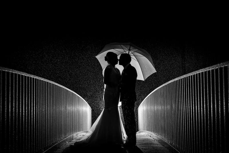 Umbrella night bridge wedding portrait at Lodore Falls Hotel
