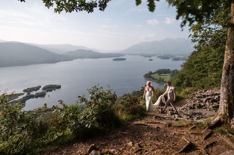 Wedding couple walking together in the Lake District landscape near Lodore Falls