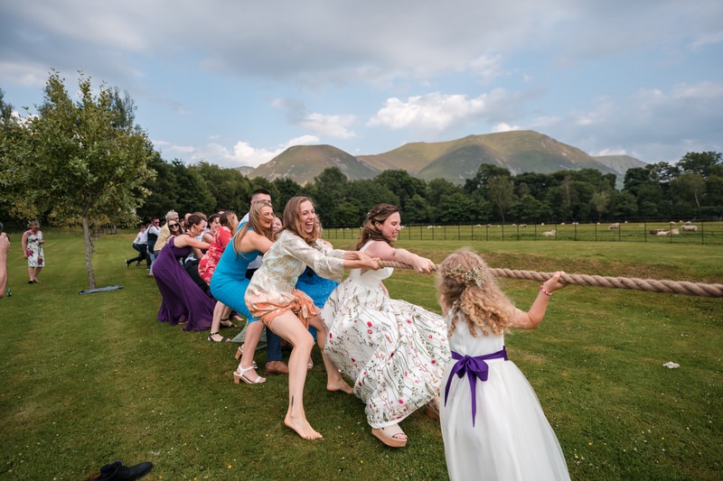 Wedding guests playing tug of war at New House Farm wedding in the Lake District