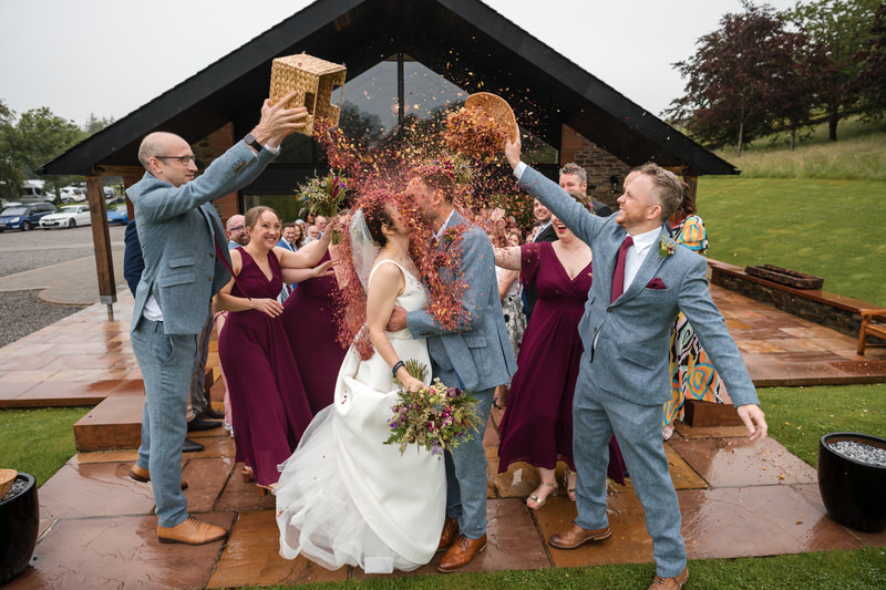 Wedding confetti moment during a couple’s kiss