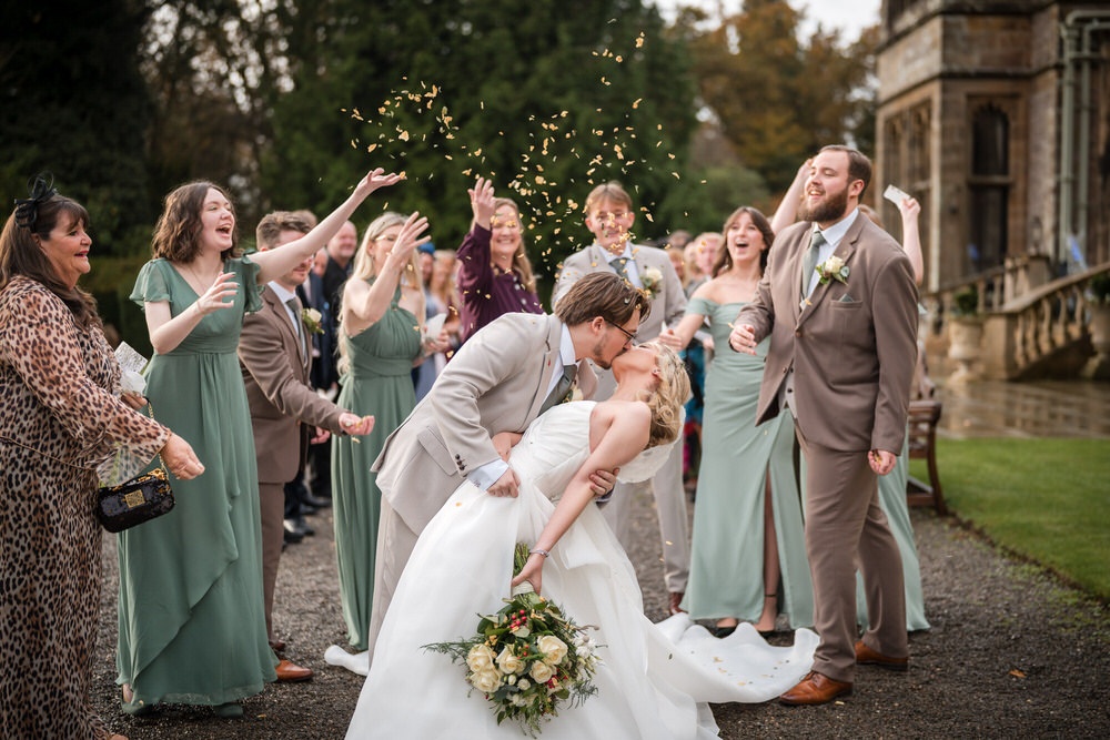 Bride and groom laughing during relaxed Lake District wedding photographs