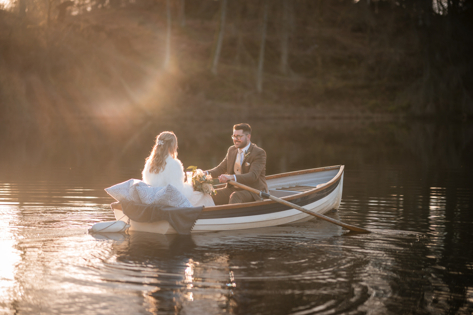 Romantic rowing boat wedding portrait on the lake at Gilpin Lake House