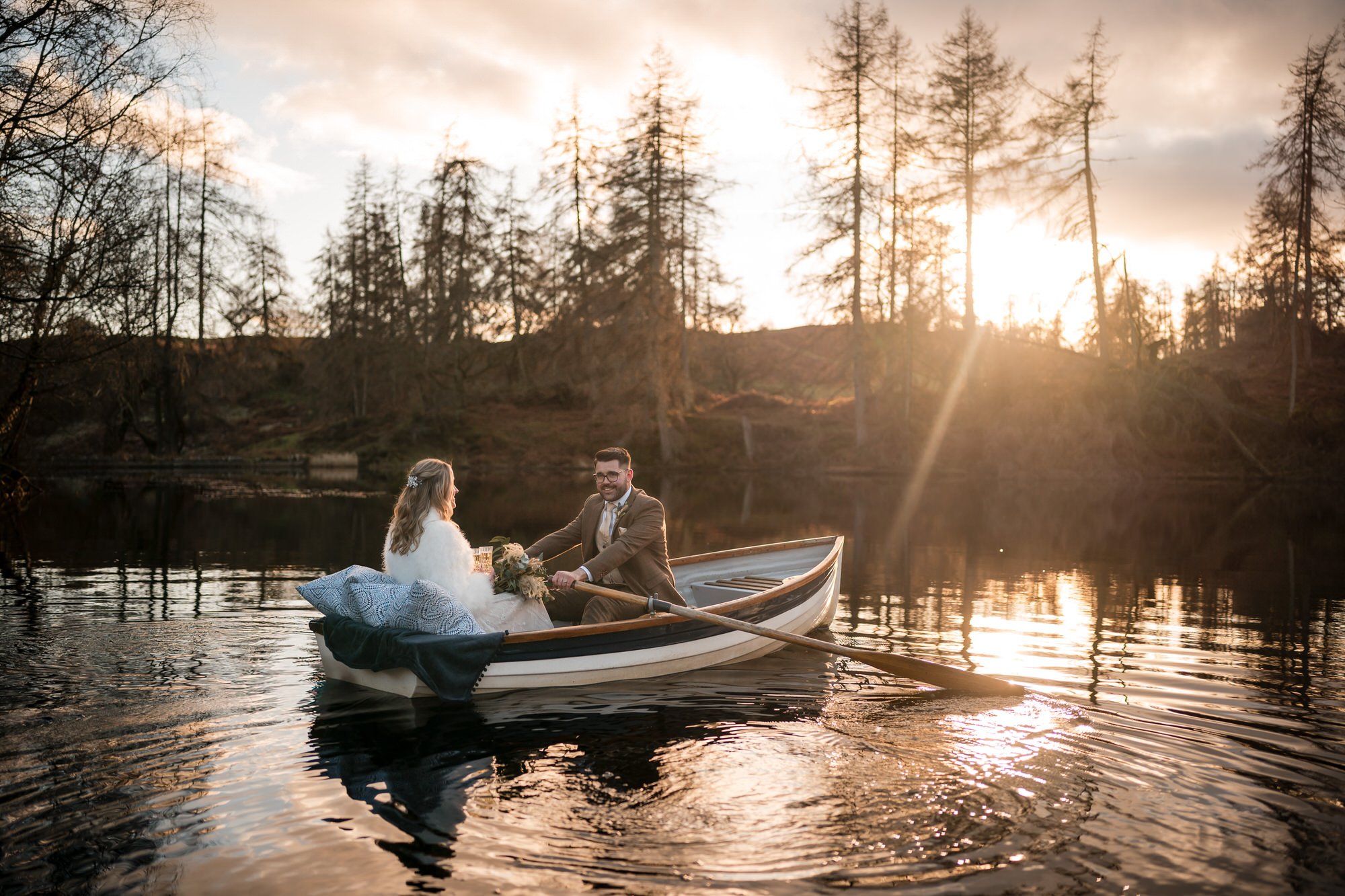 Wedding couple in a rowing boat on the private lake at Gilpin Lake House