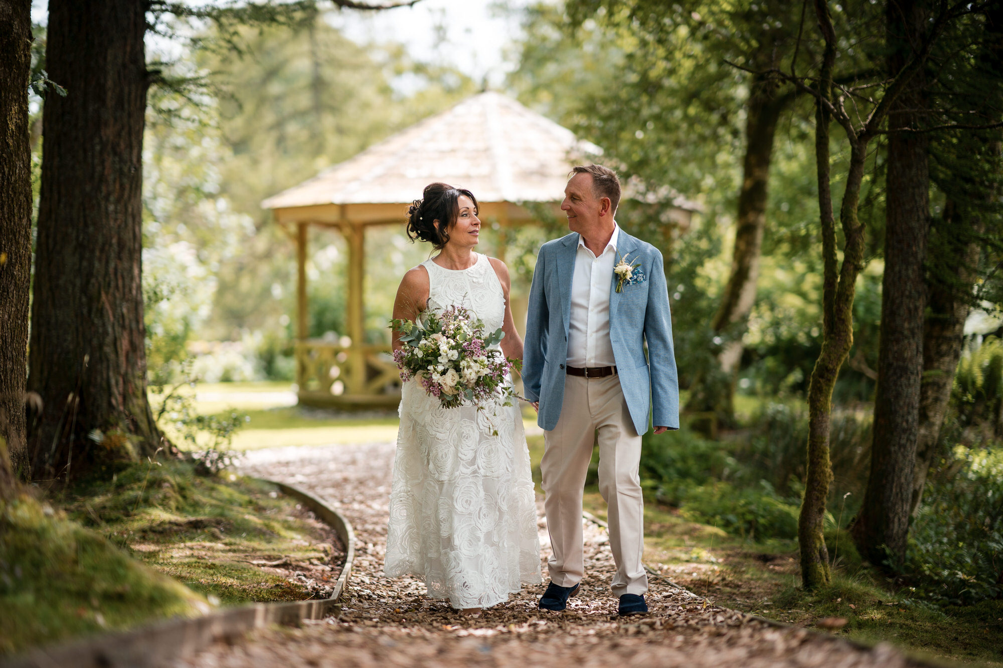 Natural wedding portraits on a woodland path at Gilpin Lake House