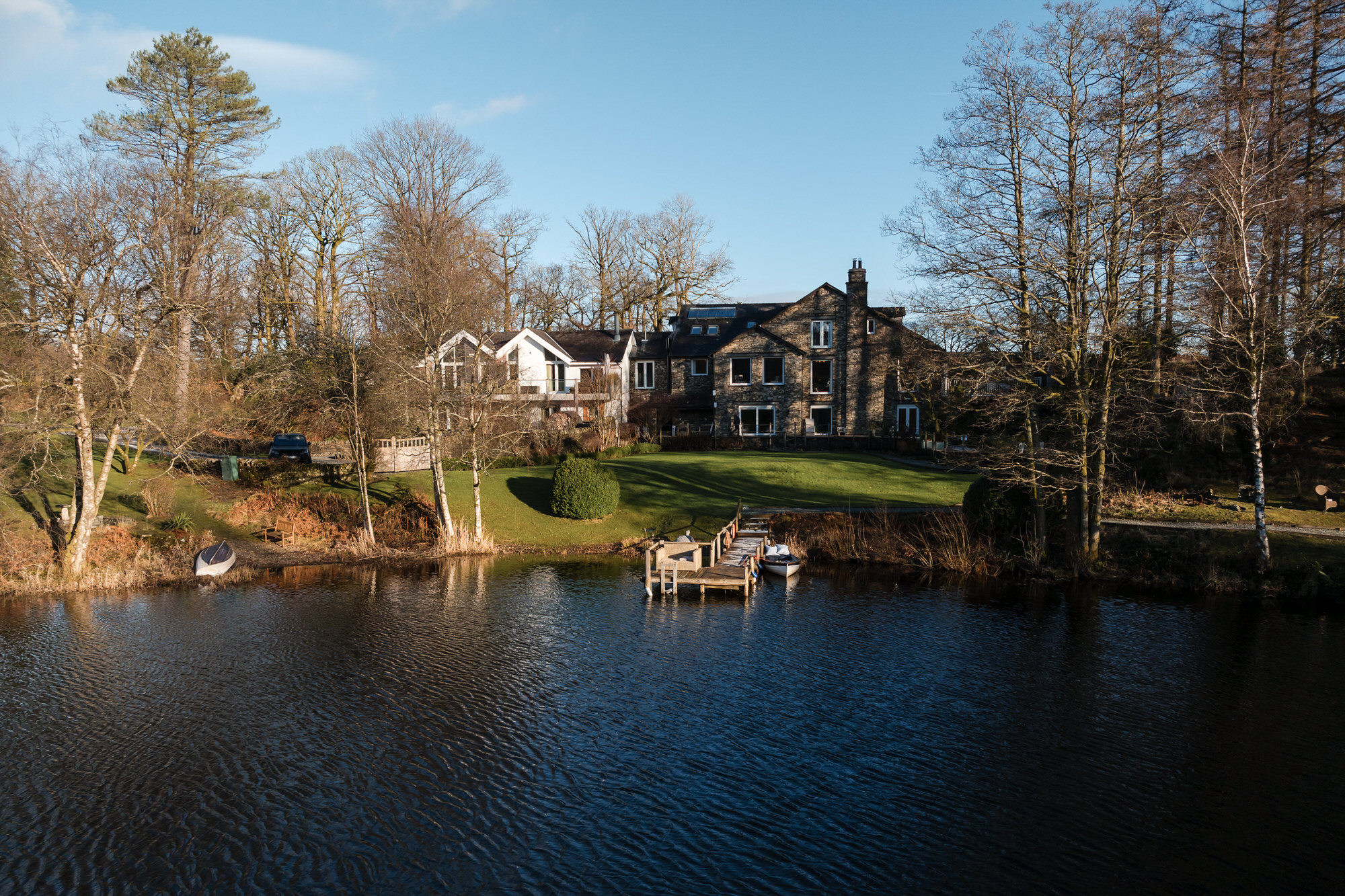 Gilpin Lake House wedding venue beside its private lake in the Lake District