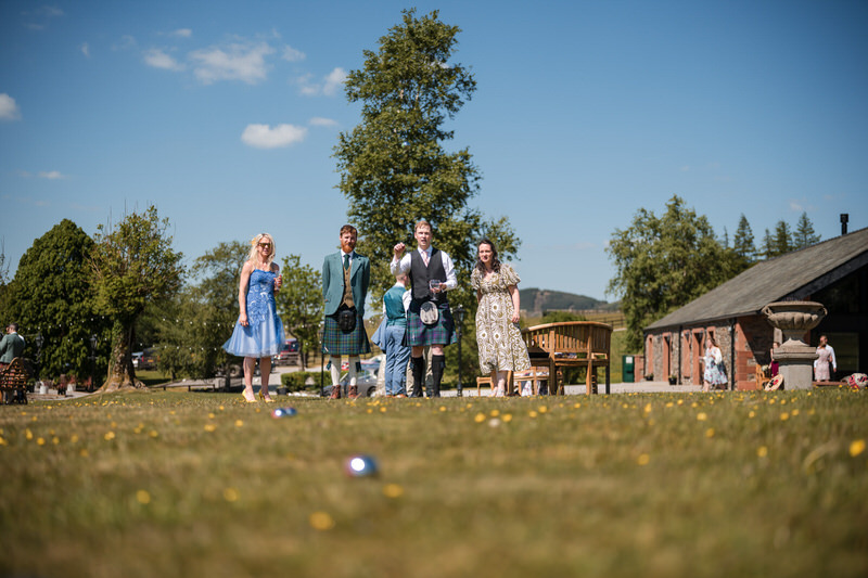 Relaxed candid moments like lawn games captured in a Lake District wedding highlight film