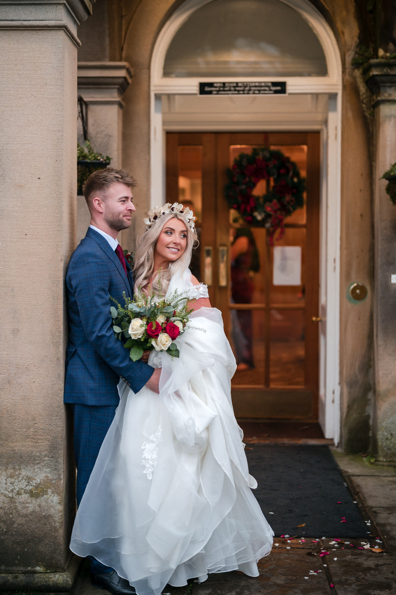 Wedding couple beneath the stone entrance arch at Hundith Hill Hotel