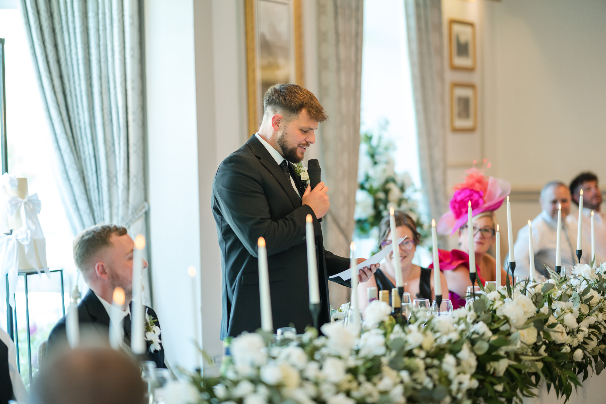 Dan giving his wedding speech at the flower-filled top table