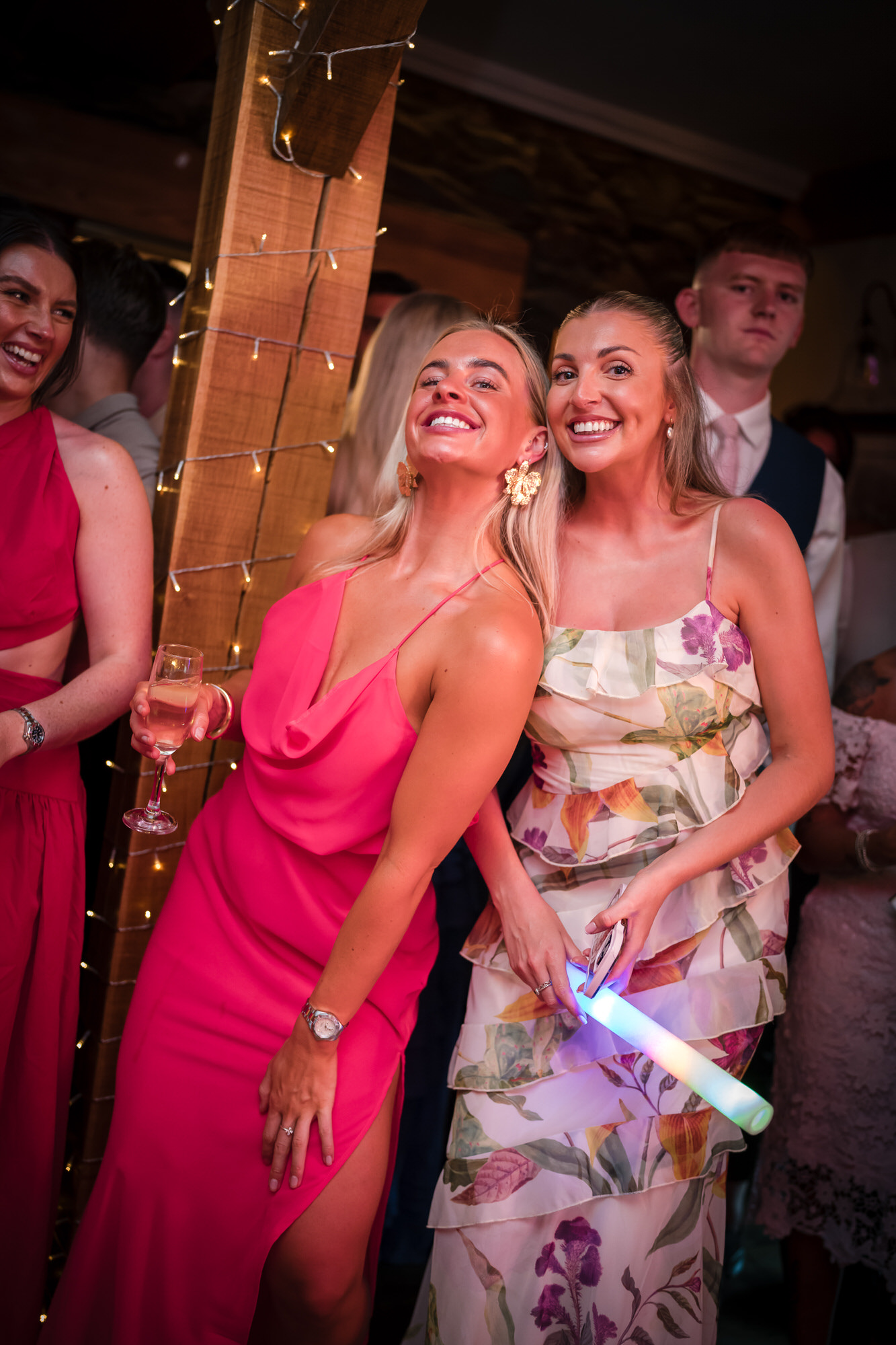 Friends laughing together on the crowded evening dance floor