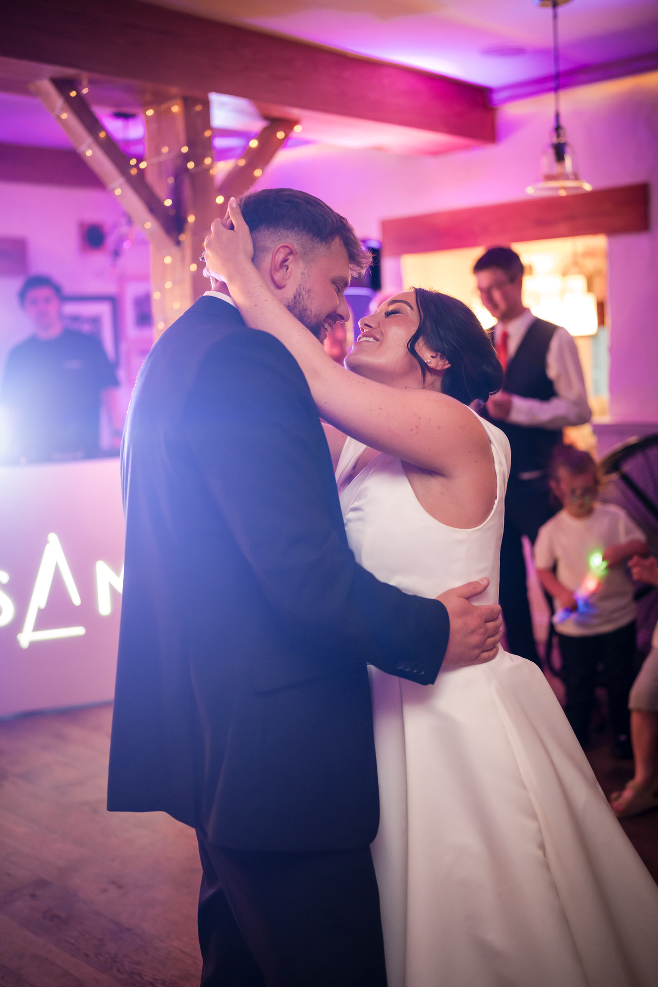 Dan and Amy smiling at one another during their first dance