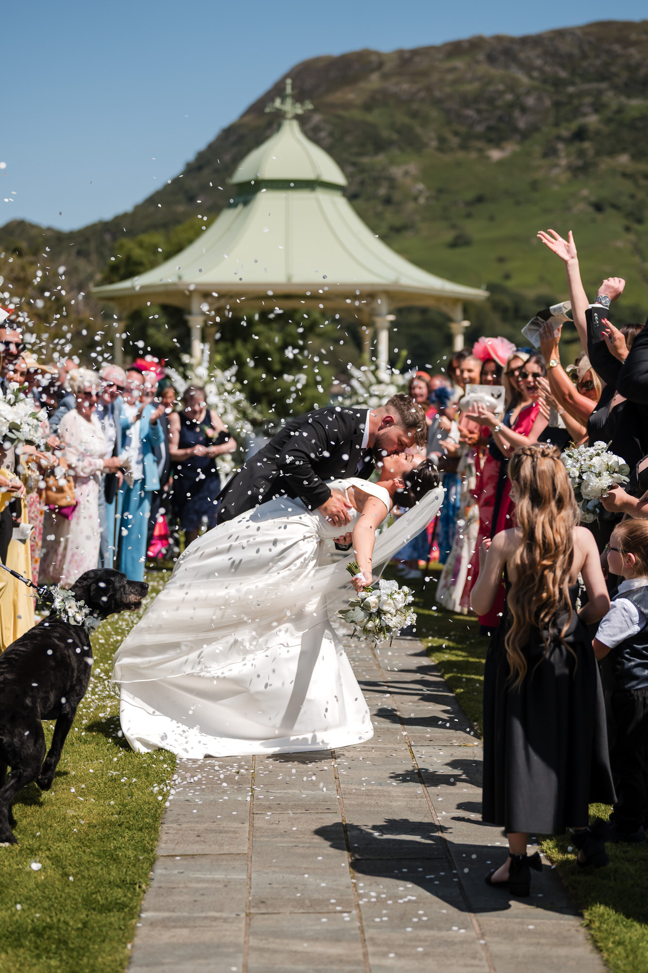 Dan and Amy walking through confetti after their outdoor Inn on the Lake ceremony