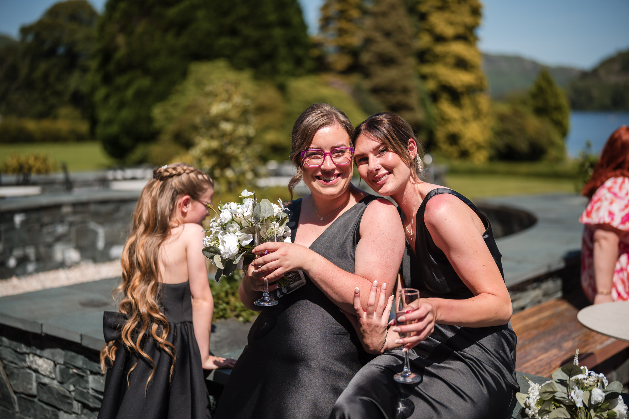 Friends laughing together during the sunny garden drinks reception