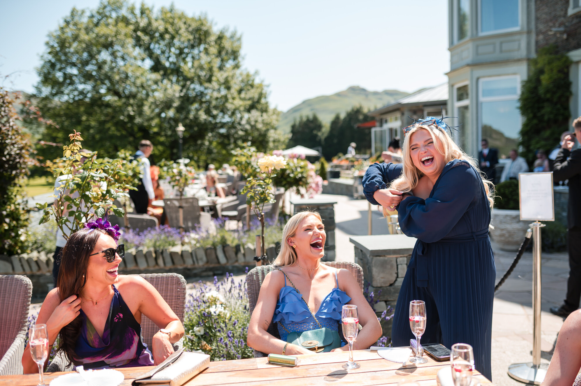 A joyful candid photograph of wedding guests at Inn on the Lake