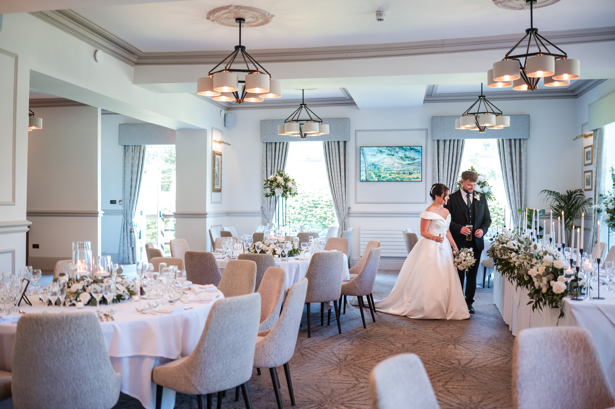 Dan and Amy entering their elegantly decorated wedding breakfast room