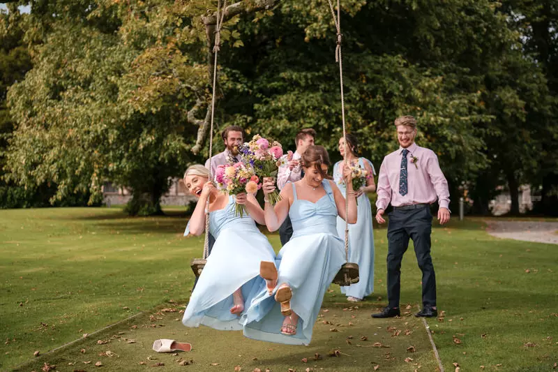 Bridesmaids having fun on a swing at Armathwaite Hall