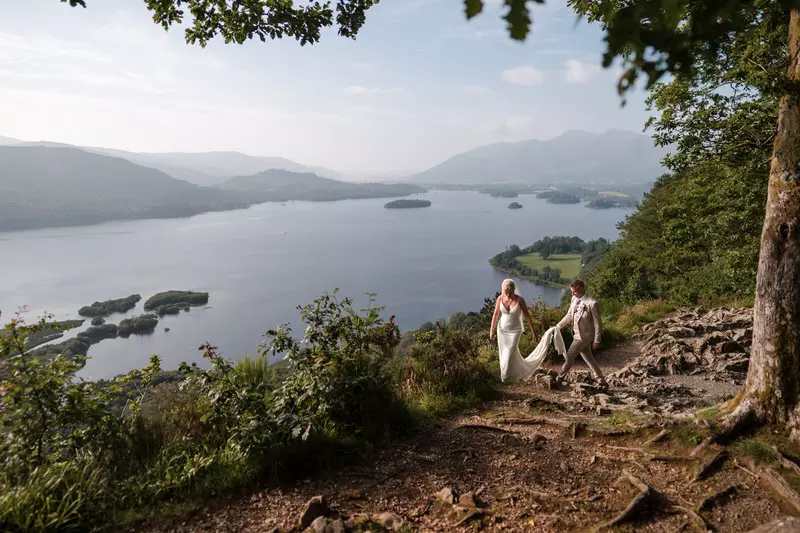 Lodore Falls wedding couple mountain walk portrait Wedding couple walking together in the Lake District landscape near Lodore Falls