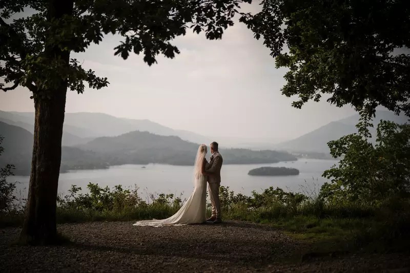 Lodore Falls wedding overlook silhouette Lake District portrait Silhouette wedding couple standing beneath trees overlooking a Lake District lake and distant hills