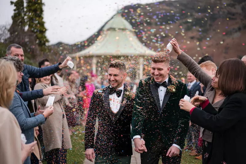 Gay wedding confetti walk at a Lake District gazebo