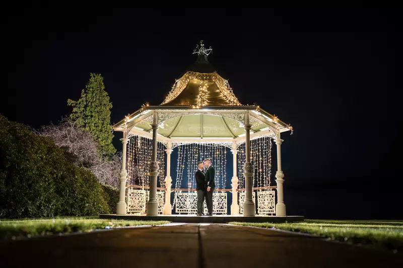 Gay wedding night portrait at a gazebo