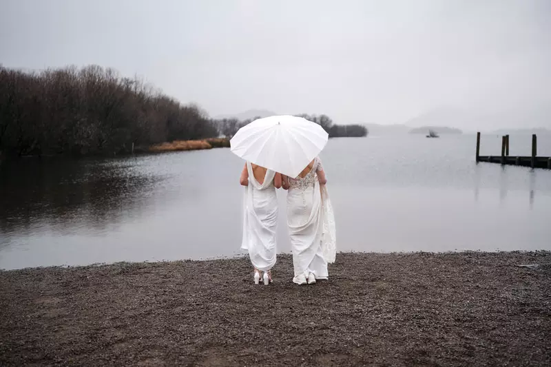 Lesbian wedding Lake District dock walk wide portrait