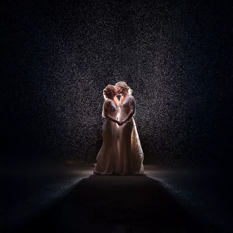 Lesbian wedding rain backlit portrait at Lodore Falls