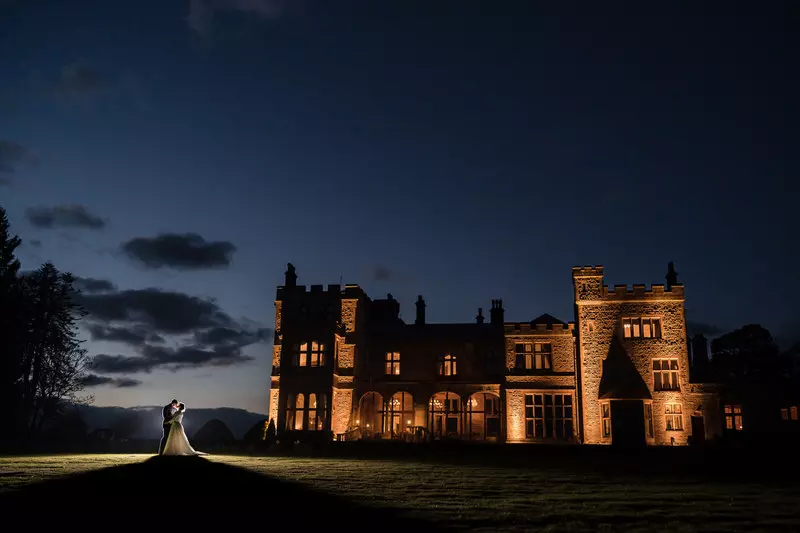 Armathwaite Hall wide night wedding portrait Wide evening portrait at Armathwaite Hall with the building illuminated at night