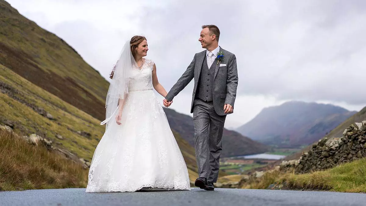 bride and groom walking up the road from their Broadoaks Country house hotel wedding bride and groom walking up the road from their Broadoaks Country house hotel wedding