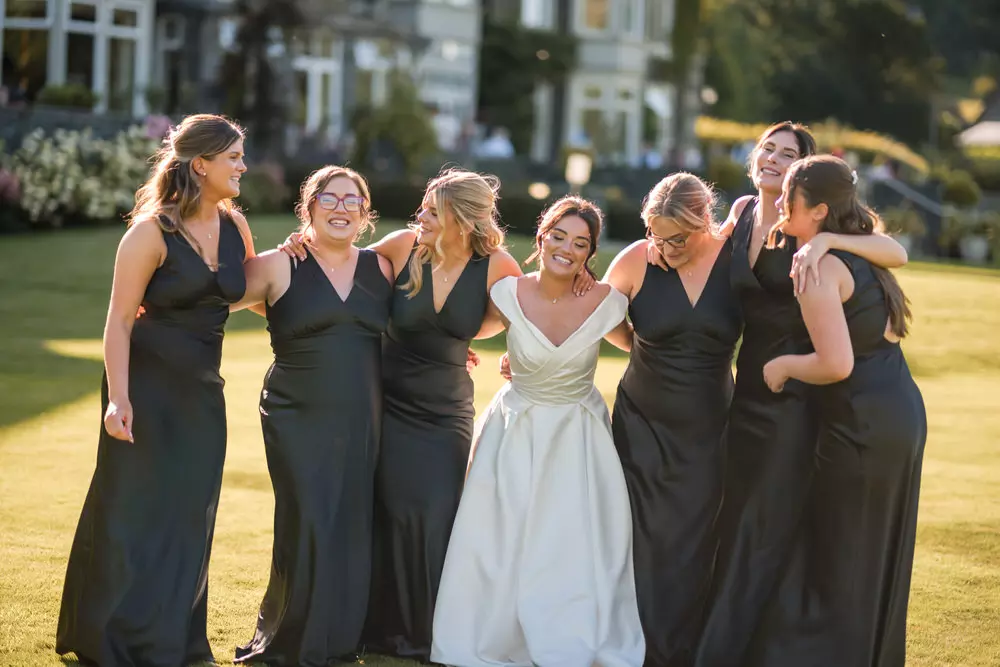 Bride with bridesmaids in soft golden light