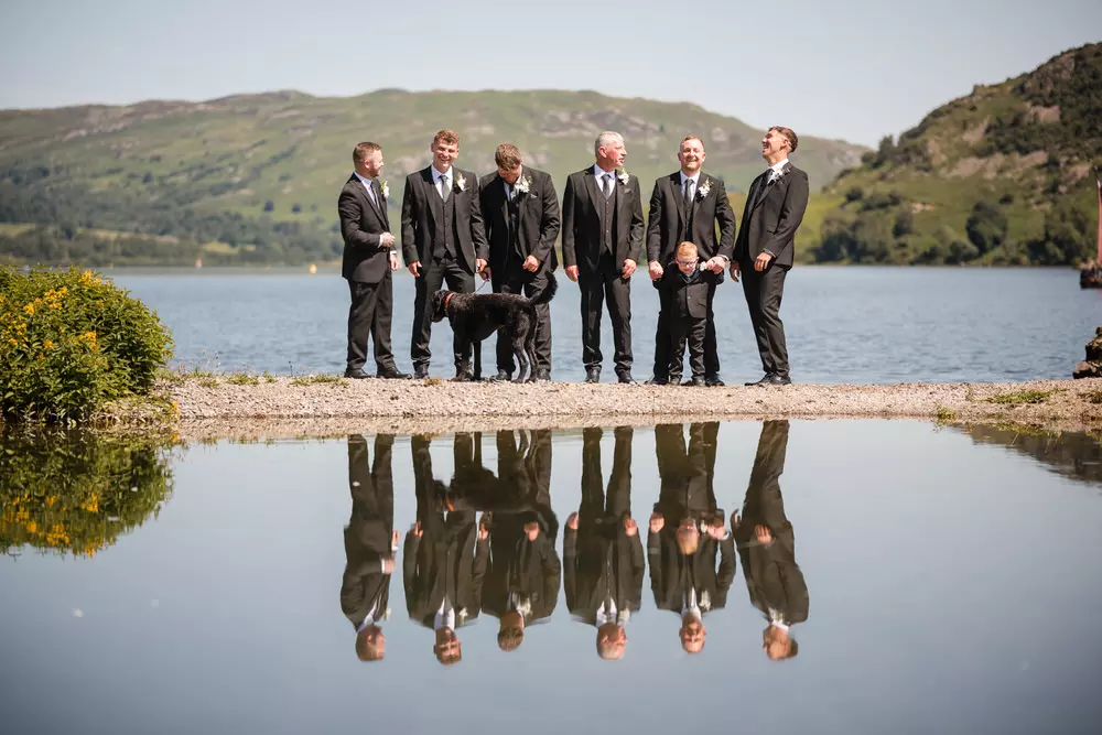 Groomsmen relaxed photo by the lake