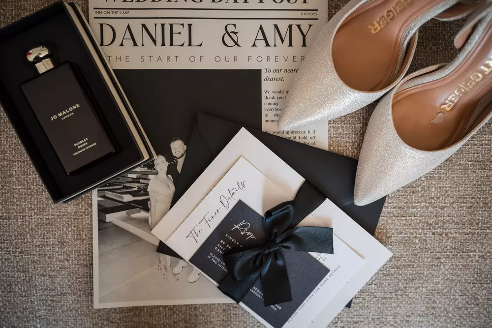 Wedding detail flat lay with invitation and shoes