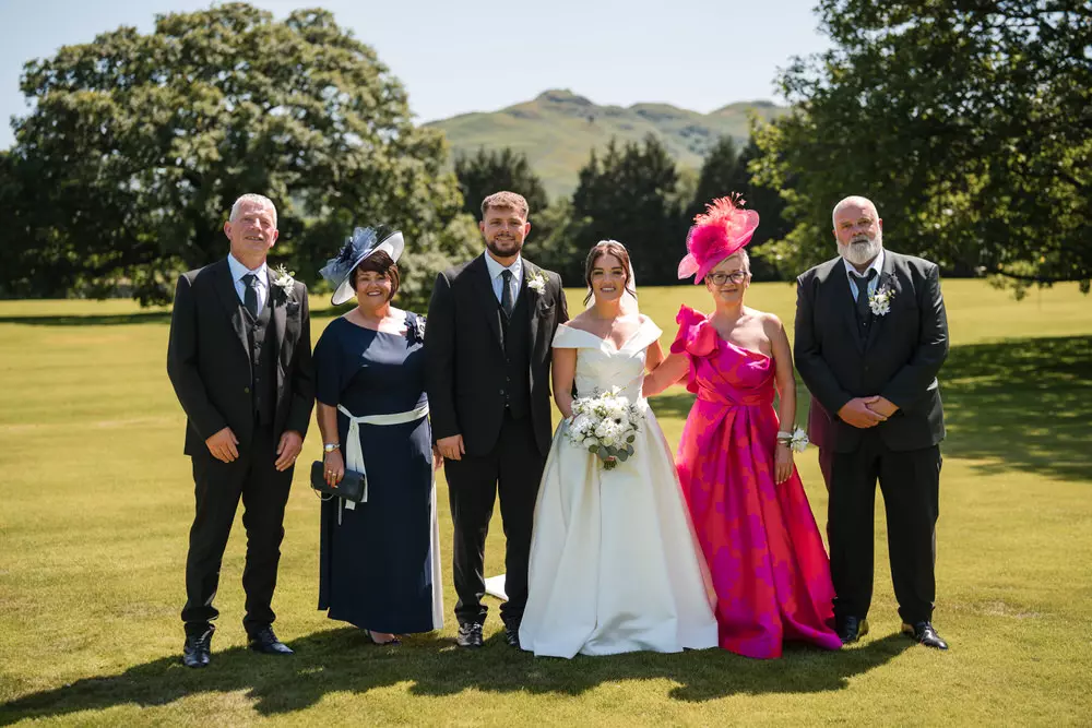 Large group photo with Lake District backdrop