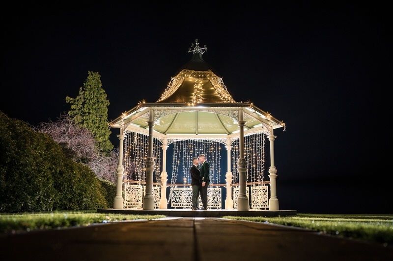 Gay wedding night portrait at a gazebo